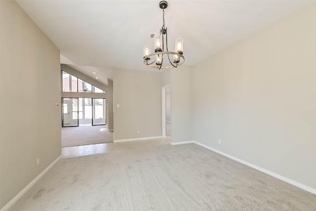 spare room featuring light colored carpet, visible vents, baseboards, vaulted ceiling, and an inviting chandelier