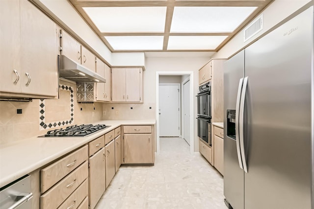 kitchen with stainless steel appliances, visible vents, light countertops, and under cabinet range hood