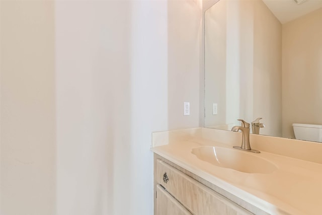 bathroom with toilet and vanity