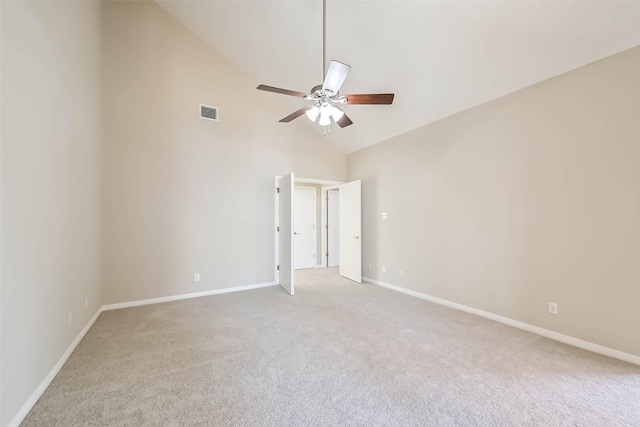 empty room with light colored carpet, visible vents, ceiling fan, high vaulted ceiling, and baseboards