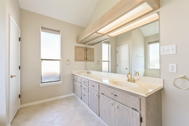 full bath featuring double vanity, a healthy amount of sunlight, vaulted ceiling, and a sink