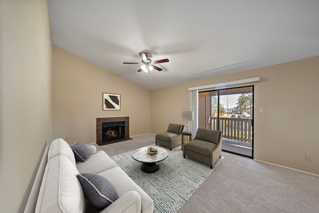 carpeted living area with baseboards, ceiling fan, a tiled fireplace, and vaulted ceiling