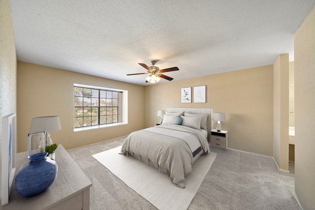 carpeted bedroom with baseboards, a textured ceiling, and ceiling fan