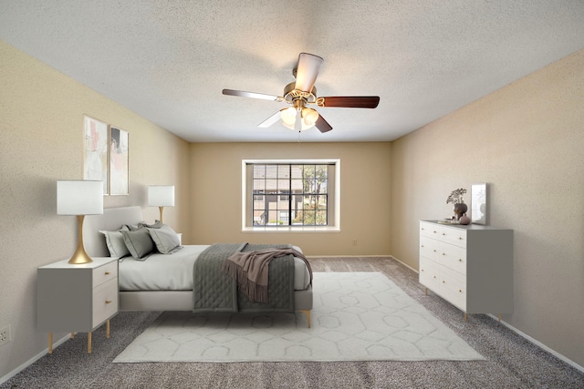 carpeted bedroom with baseboards, a textured ceiling, and ceiling fan