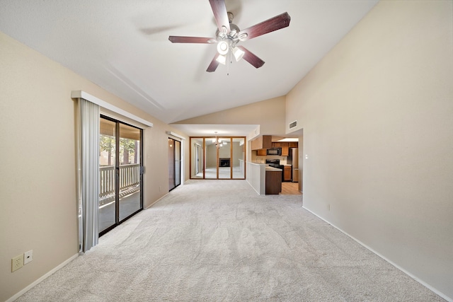 empty room with high vaulted ceiling, light colored carpet, baseboards, and ceiling fan