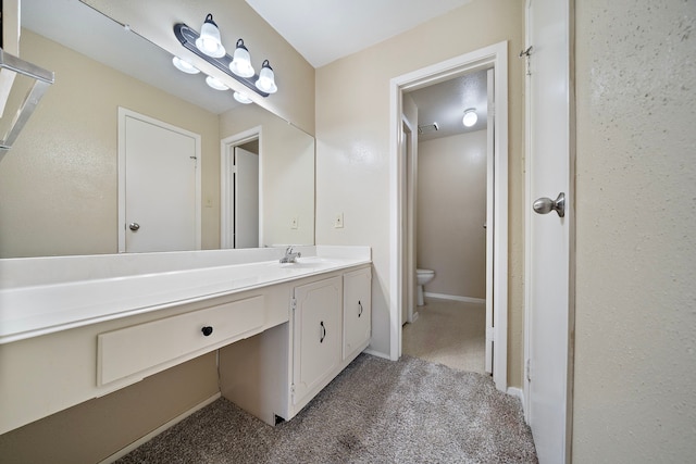 bathroom with vanity, toilet, baseboards, and visible vents