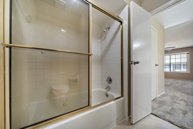 bathroom featuring speckled floor and shower / bath combination with glass door