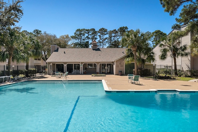 pool featuring a patio and fence