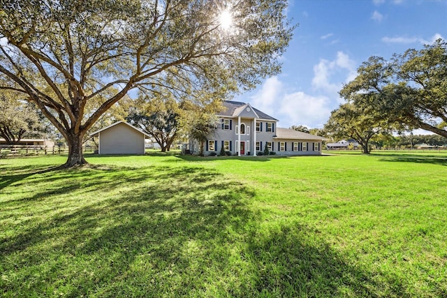 view of front of house with a front yard and fence