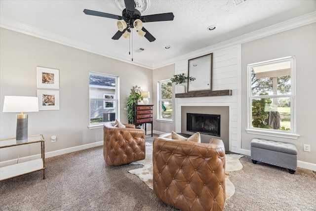 living area with carpet floors, ornamental molding, a fireplace, and baseboards