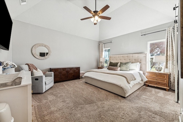 carpeted bedroom featuring visible vents, high vaulted ceiling, and a ceiling fan