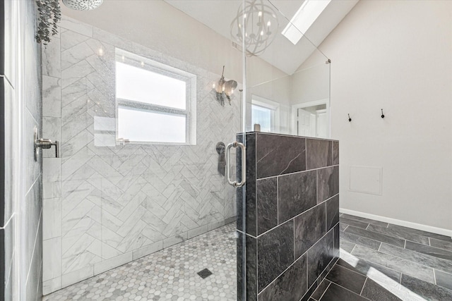 full bathroom featuring a notable chandelier, baseboards, vaulted ceiling, and tiled shower