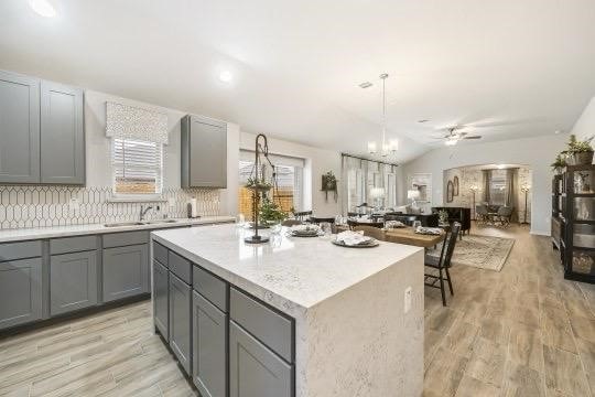 kitchen with gray cabinets, light countertops, and a center island