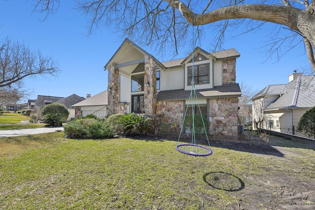 traditional home with stone siding, a residential view, and a front lawn