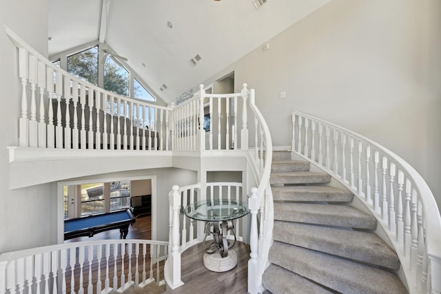 staircase featuring high vaulted ceiling, billiards, visible vents, wood finished floors, and a ceiling fan