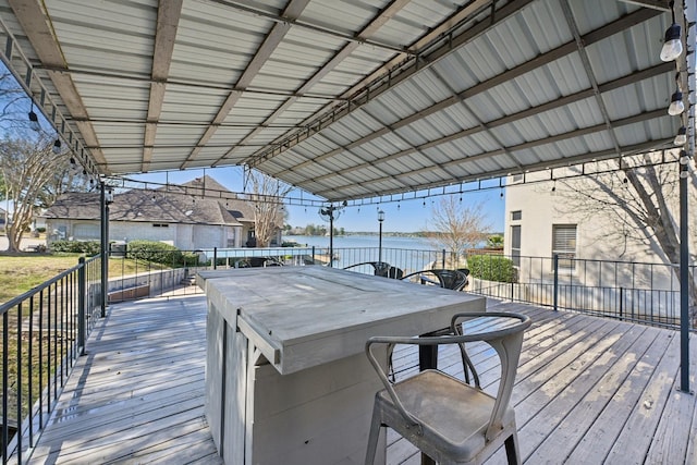 wooden terrace featuring a water view