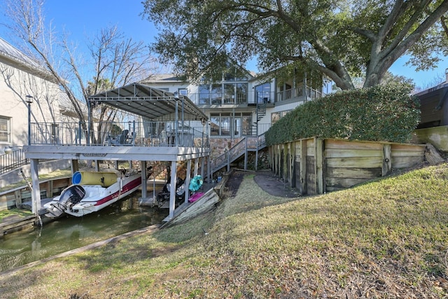 exterior space with stairs, a lawn, and a water view