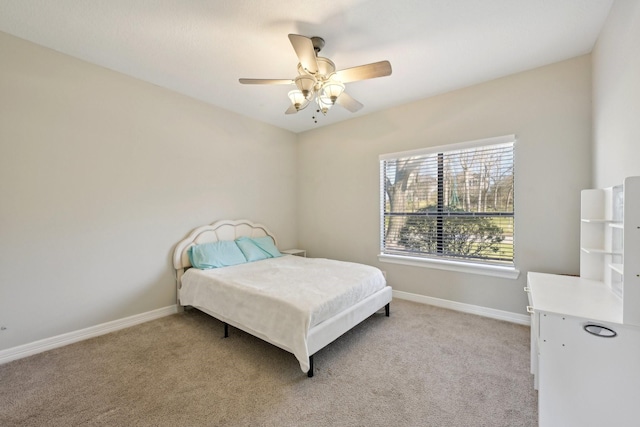 bedroom with ceiling fan, baseboards, and light colored carpet