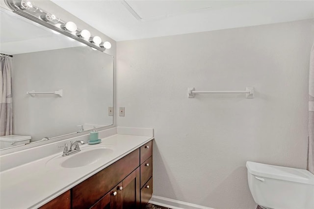 full bath with toilet, baseboards, and vanity