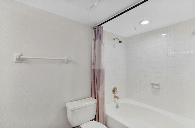 bathroom featuring shower / bath combo and toilet