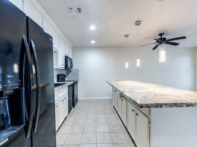 kitchen with visible vents, white cabinets, hanging light fixtures, light countertops, and black appliances