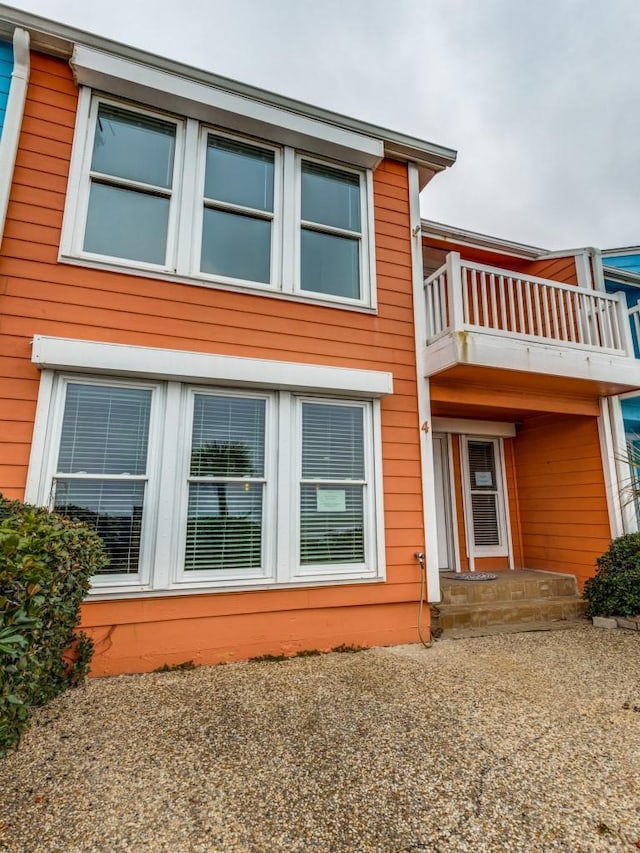 rear view of property with a balcony