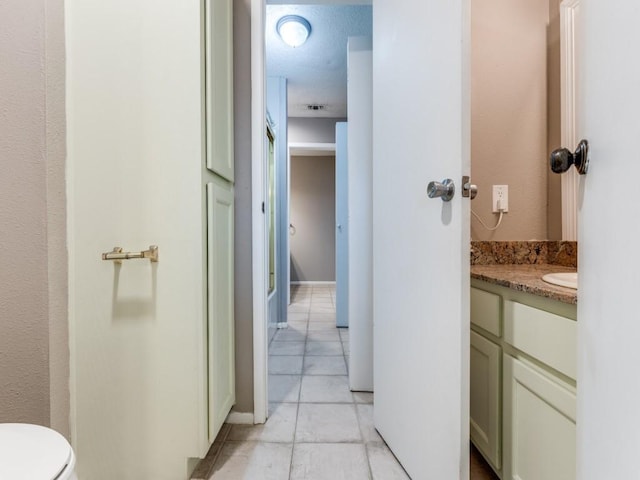 bathroom featuring toilet, visible vents, and vanity