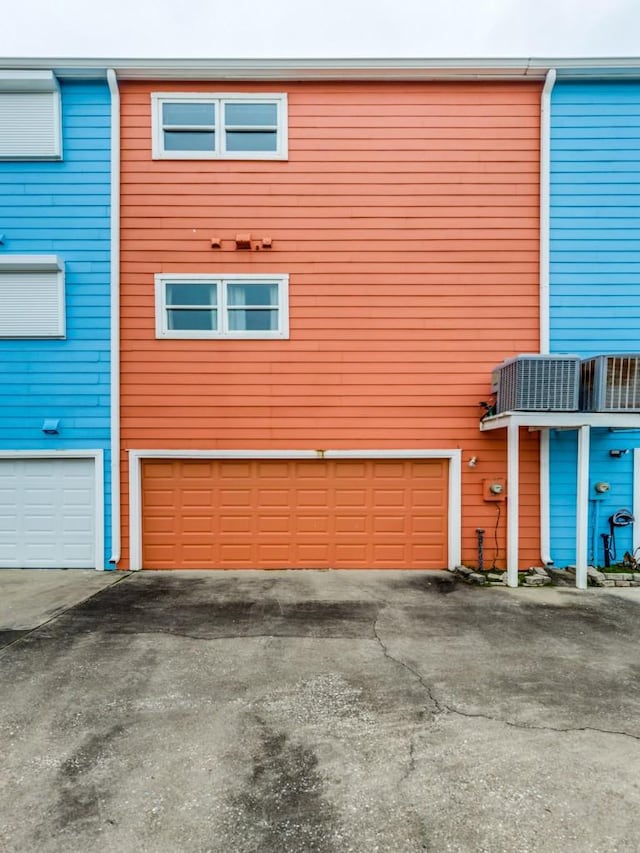 view of home's exterior with an attached garage and central air condition unit