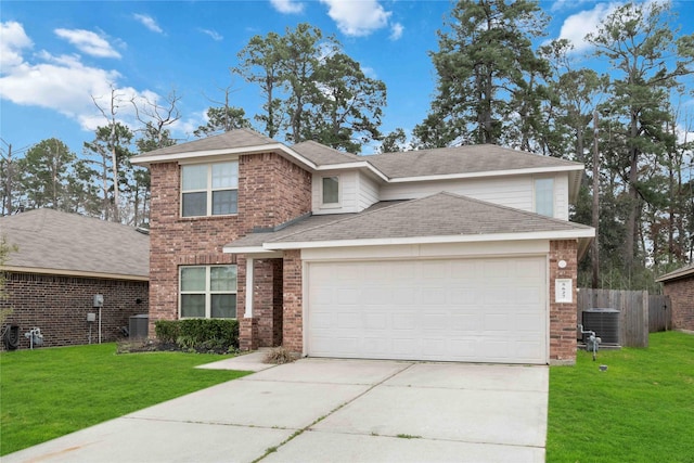 traditional home with a front lawn, an attached garage, fence, and brick siding