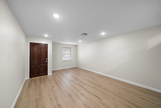 empty room featuring recessed lighting, baseboards, visible vents, and light wood finished floors