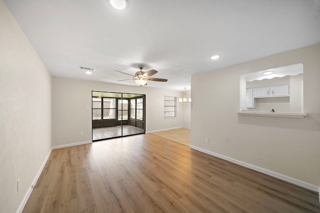 spare room featuring recessed lighting, visible vents, light wood-style floors, a ceiling fan, and baseboards