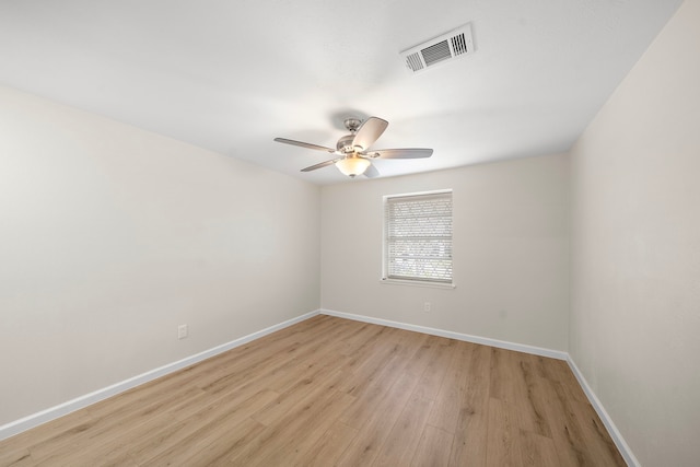 unfurnished room with light wood-style floors, baseboards, visible vents, and a ceiling fan