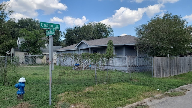 view of property exterior featuring a shingled roof, fence, and a yard