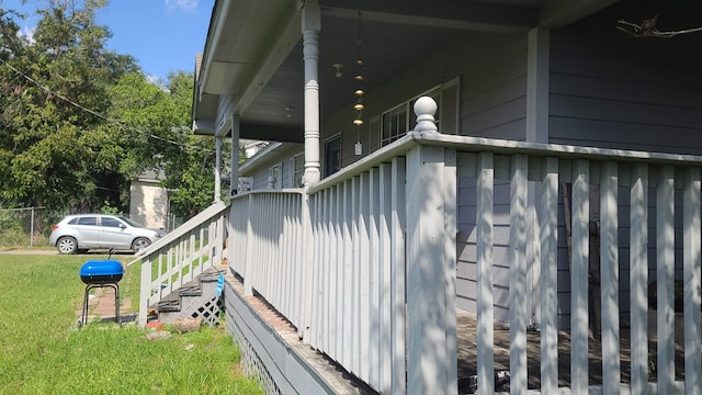 view of property exterior featuring a porch and a lawn