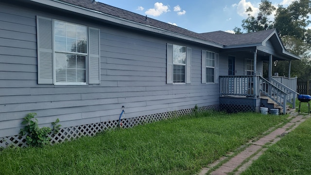 view of property exterior with crawl space, a lawn, and a shingled roof