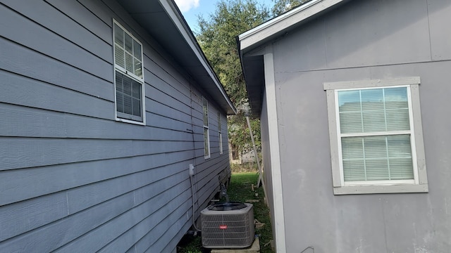 view of side of home with central AC unit