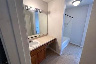 bathroom with vanity and baseboards