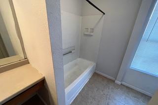 bathroom with baseboards and walk in shower