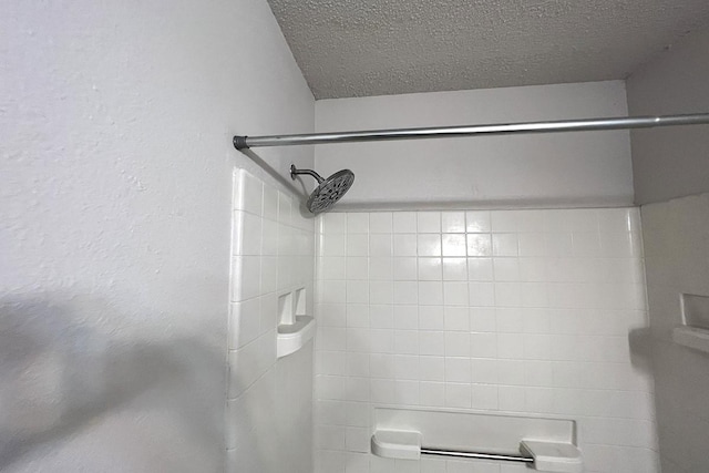 bathroom with a textured ceiling and walk in shower