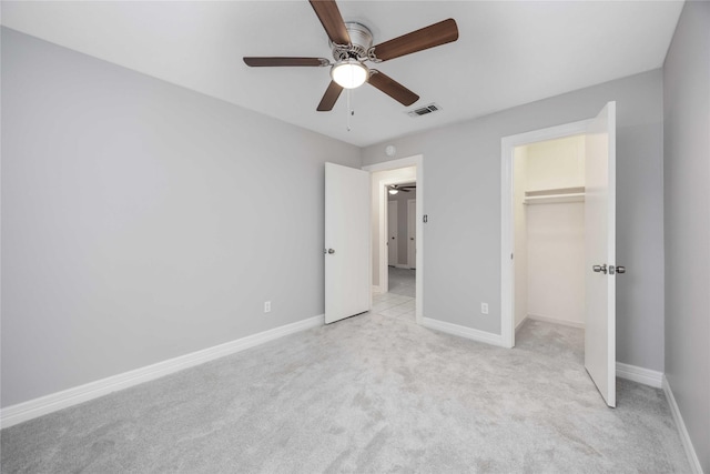 unfurnished bedroom with light colored carpet, visible vents, ceiling fan, and baseboards