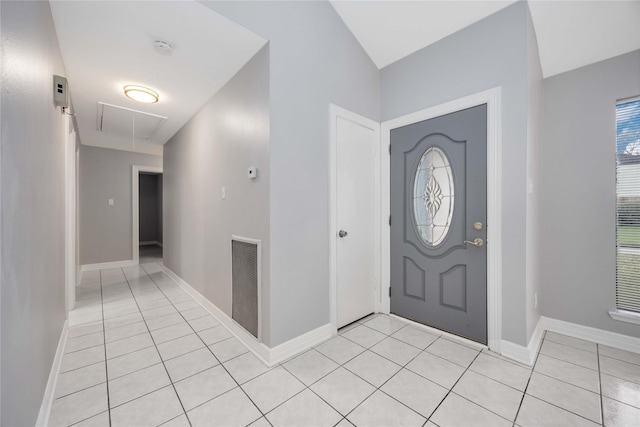 entryway with light tile patterned floors, visible vents, and baseboards