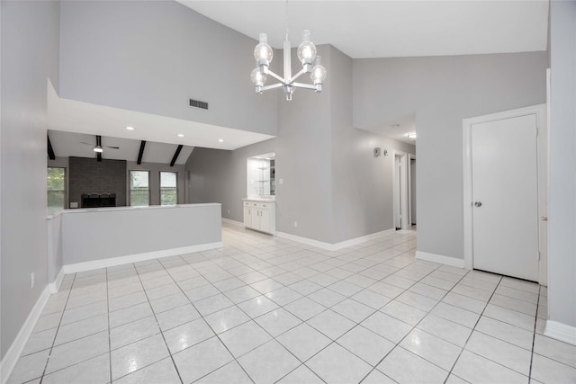 spare room featuring visible vents, a fireplace, baseboards, and light tile patterned floors