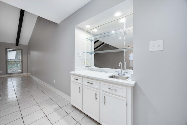 bathroom with vaulted ceiling with beams, recessed lighting, vanity, baseboards, and tile patterned floors