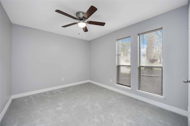 empty room with carpet, baseboards, and ceiling fan