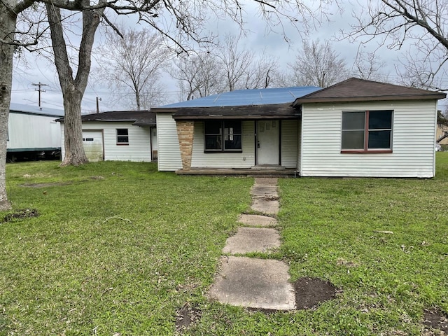 view of front of home with a garage, covered porch, and a front lawn