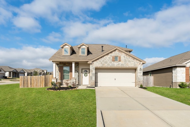 view of front of home with an attached garage, fence, a front lawn, and concrete driveway