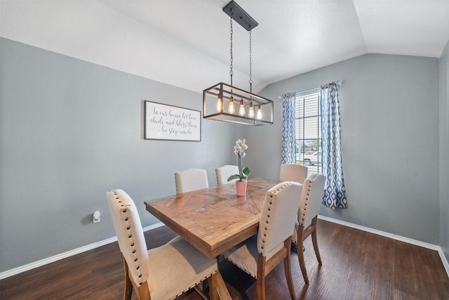 dining room with lofted ceiling, dark wood finished floors, and baseboards