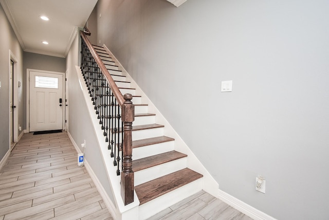 stairway with baseboards, recessed lighting, ornamental molding, and wood finished floors