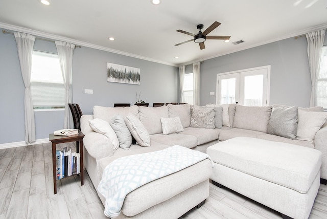 living room with crown molding, visible vents, baseboards, recessed lighting, and a ceiling fan