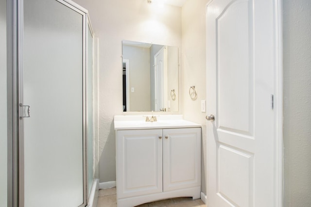 bathroom featuring a shower stall, vanity, and tile patterned floors
